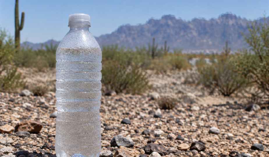 A water bottle in the desert sun